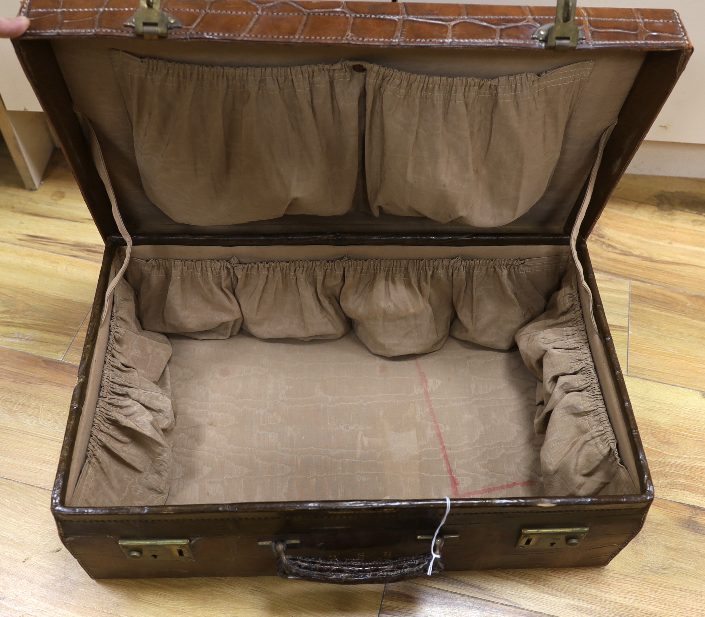 A Vintage 1930’s crocodile skin travelling case, 56cm wide